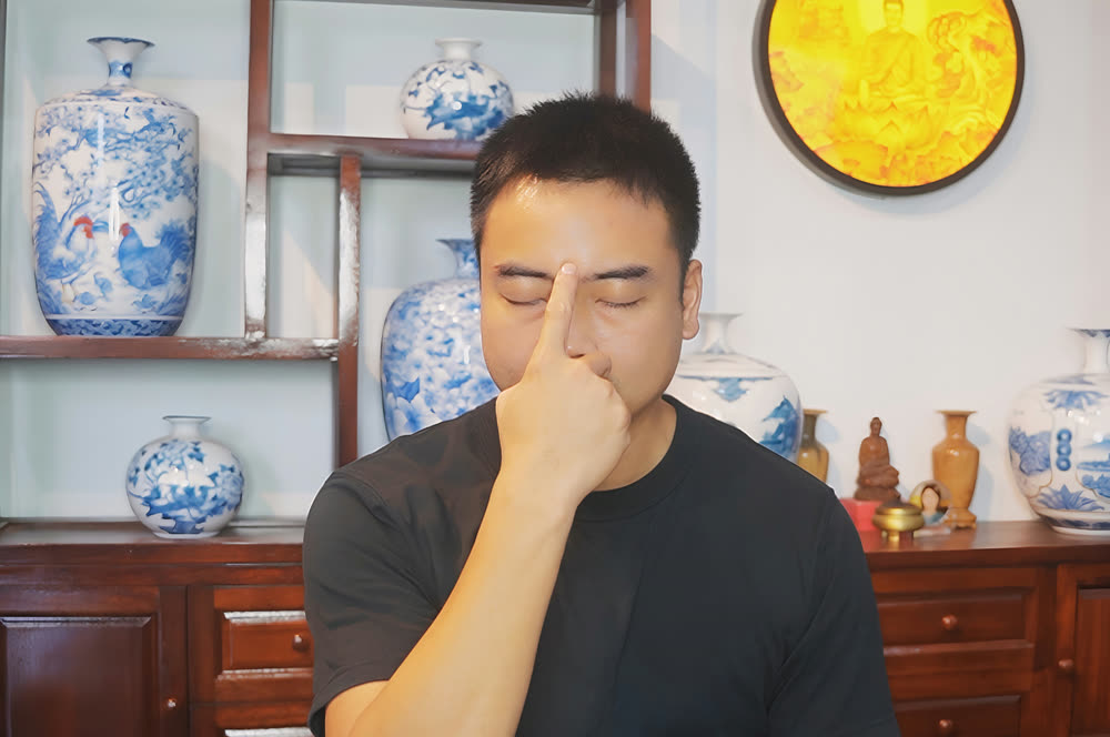 Pressing the point between the eyebrows